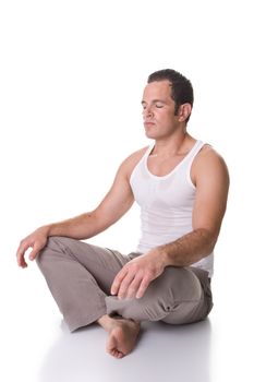 A fit young man doing relaxation and stretching exercise. Isolated on white background.
