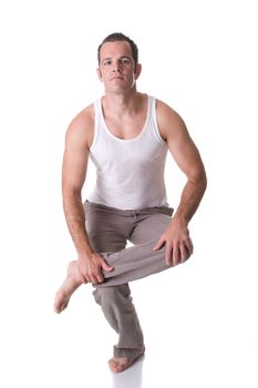 A fit young man doing relaxation and stretching exercise. Isolated on white background.