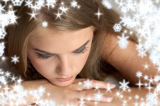 christmas portrait of pensive girl with snowflakes