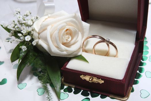 Engagement ring in a box with a rose