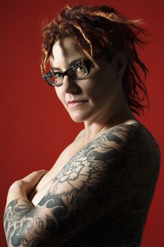 Side view portrait of adult woman with tattoos.