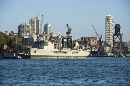 Tanker ship at port in Sydney, Australia with view of buildings.