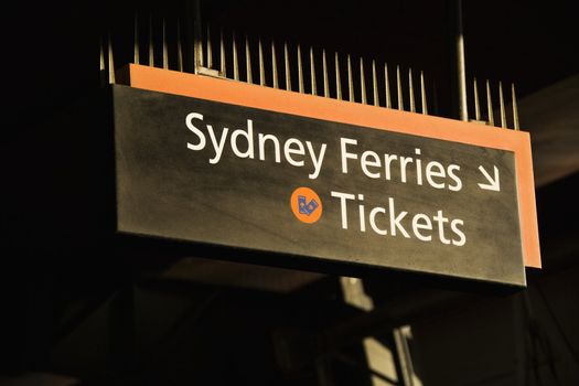 Sign pointing to ticket booth for ferryboats in Sydney, Australia.