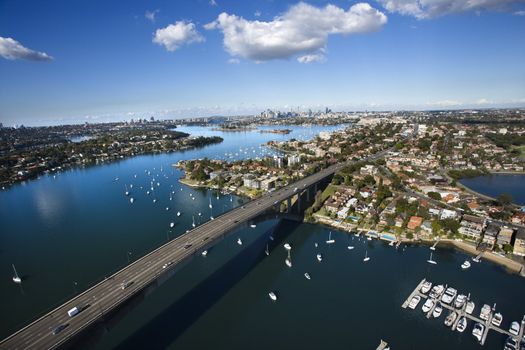 Aerial view of Victoria Road bridge and boats in Sydney, Australia.