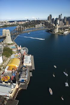 Aerial view of Luna Park Sydney, Australia with boats in Sydney harbour and view of Sydney Harbour Bridge.