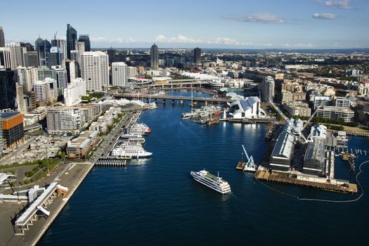 Aerial view of ships and boats in Darling Harbour with view of skyscrapers in Sydney, Australia.