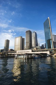 Circular Quay Railway Station in Sydney Cove with view of downtown skyscrapers in Sydney, Australia.