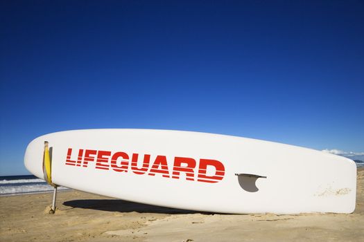 Lifeguard surfboard on beach in Surfers Paradise, Australia.