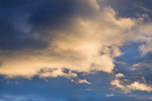 Colorful cumulus clouds in sky.