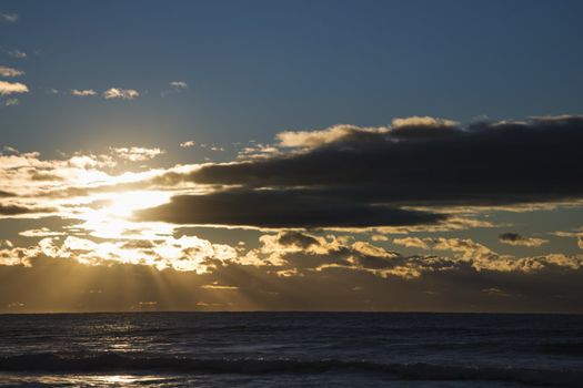 Cumulus clouds at sunset over ocean in Surfers Paradise, Australia.