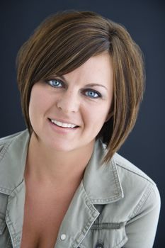 Caucasian mid adult brunette woman smiling at viewer.