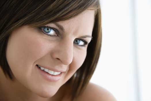 Caucasian mid adult brunette woman smiling at viewer.