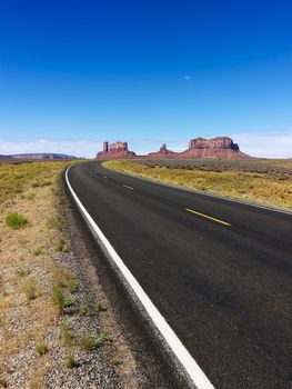 Scenic desert road with mountain land formations.