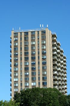 A Hi-rise apartment building against blue sky