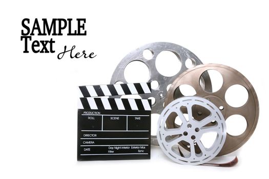 Movie Production Film Canisters With Directors Clapboard on White Background and Copy Space