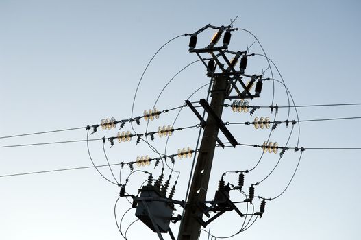 Electricity pole and wiring against the blue sky