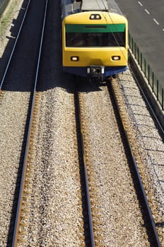 Oncoming suburban train on railway tracks.