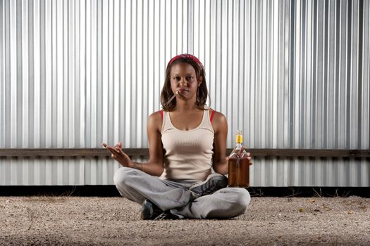 Woman meditating with cigar and tequila bottle