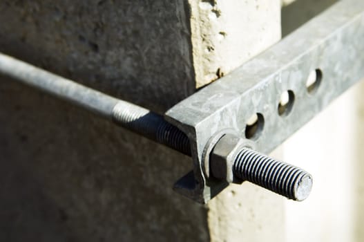 Detail of a metal clamp in a concrete electric pole