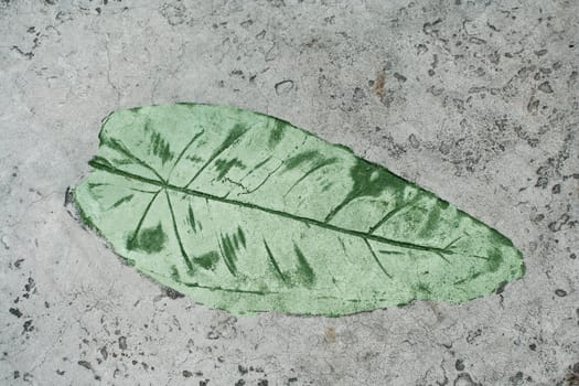 Green Leaf impression in a cement sidewalk