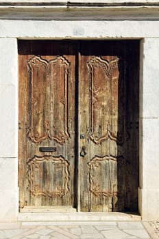 Ancient abandoned old door with nice woodcarvings 