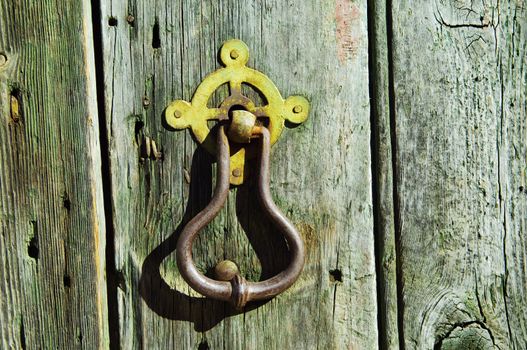 Detail of a vintage weathered door with rusty handle