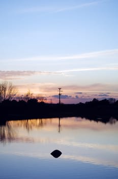 Lake at sunset with a beautiful smooth water surface 