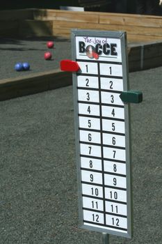 A Bocce ball score board on a court