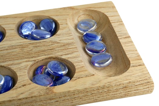 A Wooden mancala game with blue stones