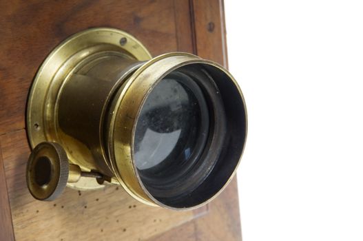 Detail of a vintage wooden camera showing the old lens