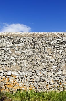 Ancient rustic stone wall beautifully preserved in a shiny day