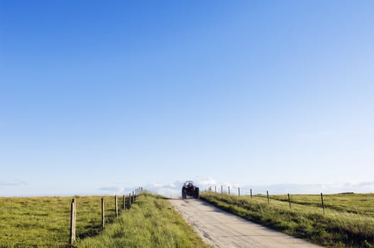 Tractor moving away in a beautiful country road.  Alentejo, Portugal