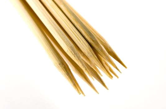 Closeup of wooden skewers on a white background