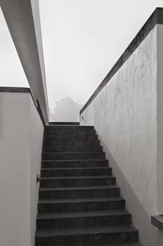 Narrow staircase in a modern building, monochrome
