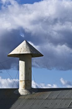 Conical vent chimney on a rooftop of an old factory
