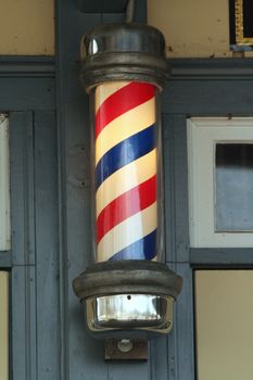 A Old barber pole on a building