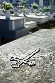 Closeup of a cross engraved in a tombstone in Alentejo, Portugal