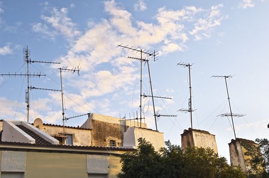 Bunch of old television aerials in a a small town
