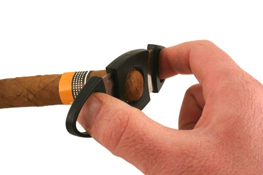 A Hand cutting a cigar on white background