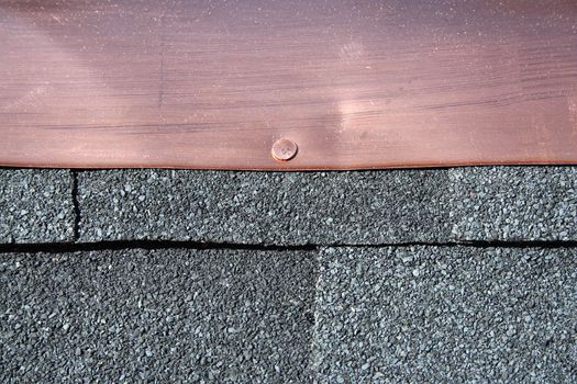 Black asphalt roofing shingles with copper flashing