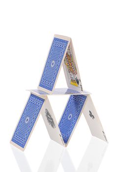 rickety structure from playing-cards on white