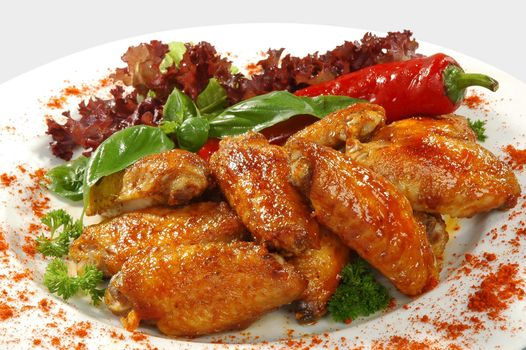 fried chicken wings in friture with red pepper