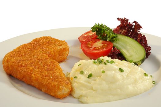 chicken chop, mashed potatoes, tomato and cucumber on a dish