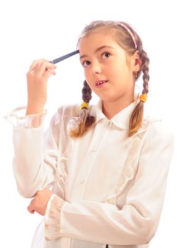 thoughtful schoolgirl holds a pen at a forehead