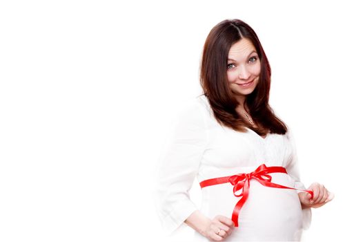 Smiling pregnant woman with red ribbon tied over white