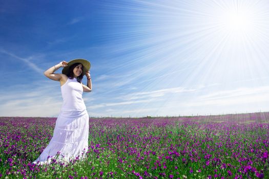 beautiful young woman with white dress in flower field - landscape orientation