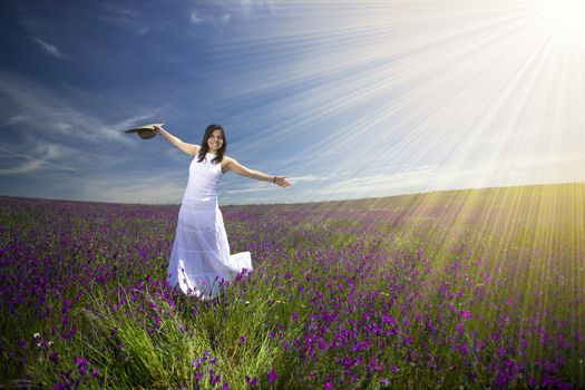 beautiful young woman with white dress in flower field - landscape orientation