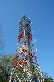 A Radio antenna tower against a blue sky