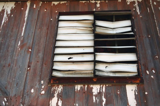 An old Old broken louvered Window 