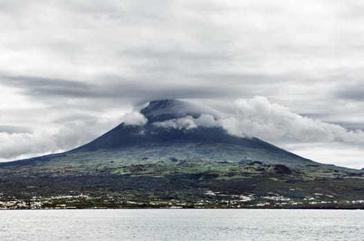 Overcast sky over Pico volcanic mountain view from the sea, Pico island, Azores, Portugal
